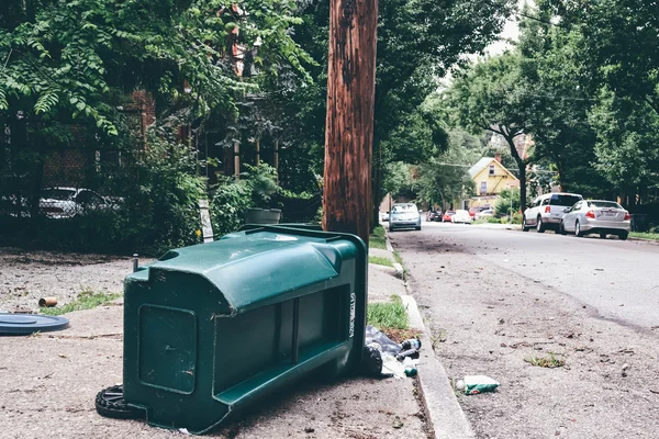 CINCINNATI, OH - CIRCA 2011: fallen green trash bin street in Clifton neighborhood in Cincinnati, OH, USA at summer 2011.