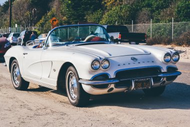 MALIBU, CA - CIRCA 2011: white retro car on Malibu beach on a sunny day in California, USA in summer 2011.