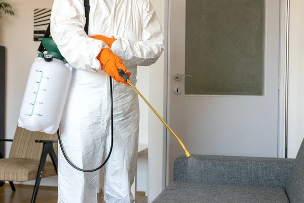 Person Protective Suit Decontamination Sprayer Bottle Disinfecting Household Furniture Royalty Free Stock Photos