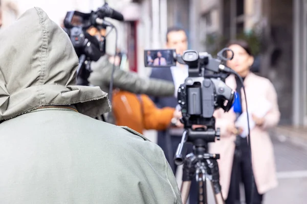 Filming an media event or news conference with a video camera. Public relations - PR concept.
