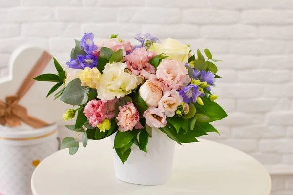 Fresh flowers in box, beautiful flower arrangement on table.