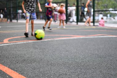 Koçu olan bir çocuk sahada futbol oynuyor. Bir adam küçük bir futbolcuyu eğitir..