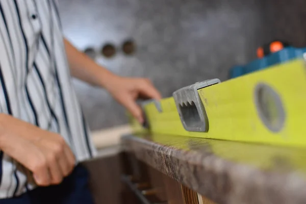 household help at home. woman with construction tool