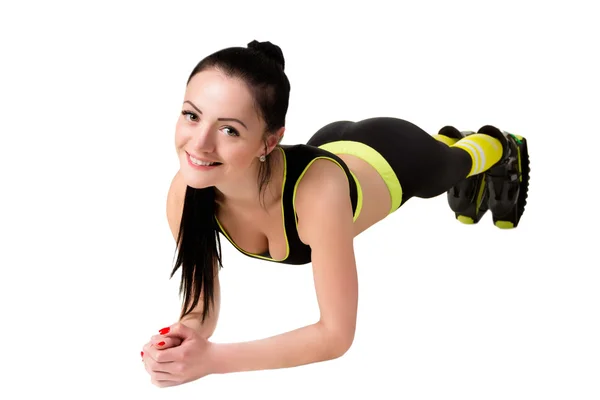 Schlankes lächelndes Mädchen in Kangoo-Jumps-Schuhen bei Plank-Übungen. — Stockfoto
