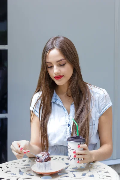 Giovane donna attraente mangiare torta con caffè in caffè all'aperto — Foto Stock