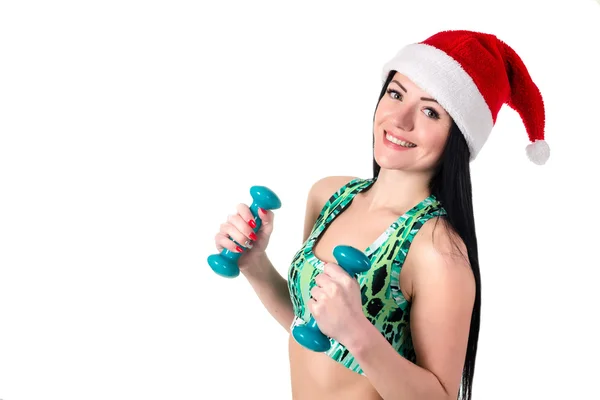 Claus Santa egzersizleri yapıyor şapkalı sportif esmer kız 