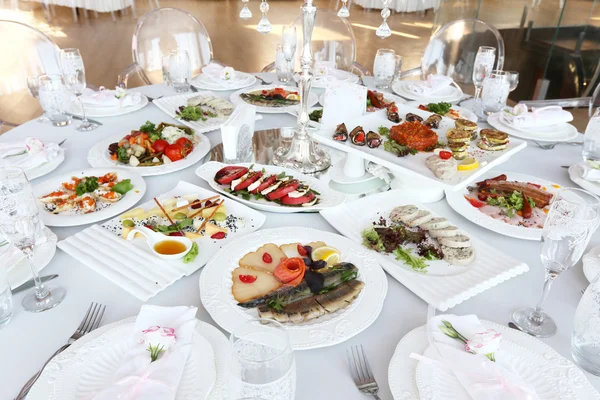 Banquet table with dishes in restaurant — Stock Photo, Image
