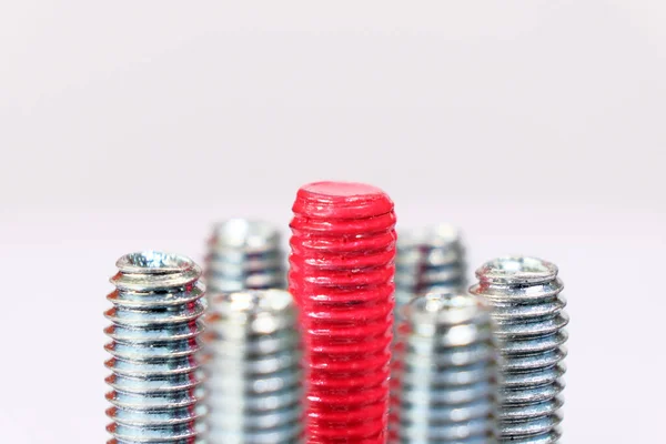 Closeup Red Bolt Group Galvanized Metallic Screws Leadership Individuality Originality — Stock Photo, Image