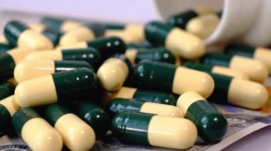 Amerikan doları banknotları ve dönen bir masanın üzerinde bir sürü ilaç..