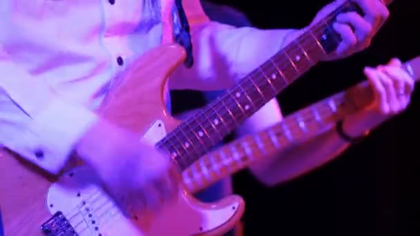 Man ritmegitarist speelt elektrische gitaar op een rockconcert in een club. — Stockvideo