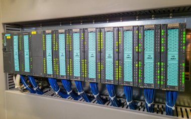 Sanayi tesisi ekipmanlarının otomatik kontrolünün elektrik dolabında arka arkaya PLC modülleri