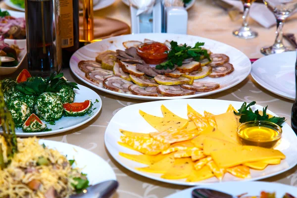 Meats and cheeses on banquet table — Stock Photo, Image