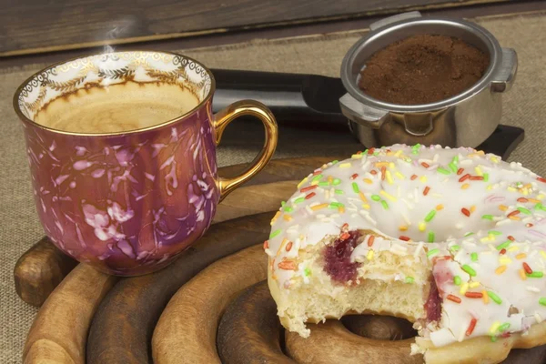 Sweet breakfast. Fresh coffee and a donut. Sweet treats to hot coffee. Traditional dessert, filled donut.
