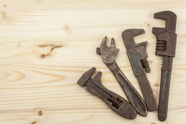 Παλιά σκουριασμένα εργαλεία μηχανικής σε ένα ξύλινο φόντο. Διαφήμιση για νέα εργαλεία. Εργαλεία πωλήσεων. Θέση για το κείμενό σας. — Φωτογραφία Αρχείου