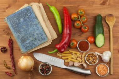Ahşap bir masada eski yemek kitabı tarifleri. Cook sağlıklı sebze. Ev diyet gıda hazırlanması. Farklı sebze çeşitleri.