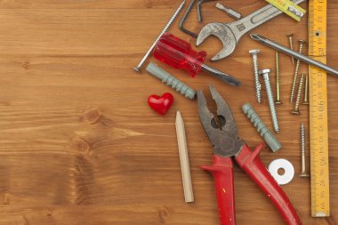 Set of tools and instruments on wooden background. Different kinds of tools for household chores. Home repairs. Father's Day.