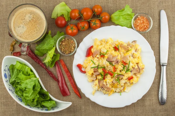 Homemade breakfast with a cup of coffee.Fresh scrambled eggs with bacon and vegetables. Breakfast athletes. Preparing eggs. Protein diet. Eggs in different kinds of preparations.