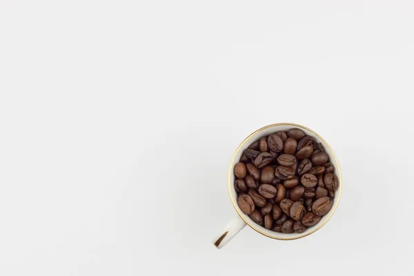 Freshly roasted coffee beans, packed in a cup. We like strong coffee. Sales of fresh coffee. Advertising on a cafe. — Stock Photo, Image