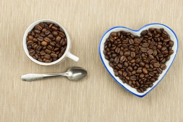 Roasted coffee beans on the kitchen table. Fresh coffee. Preparation of hot coffee. Refreshing drink. Sales of coffee beans. Advertising for coffee shop. We love fresh coffee.