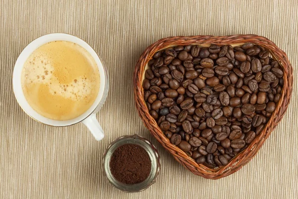 Roasted coffee beans on the kitchen table. Fresh coffee. Preparation of hot coffee. Refreshing drink. Sales of coffee beans. Advertising for coffee shop. We love fresh coffee.