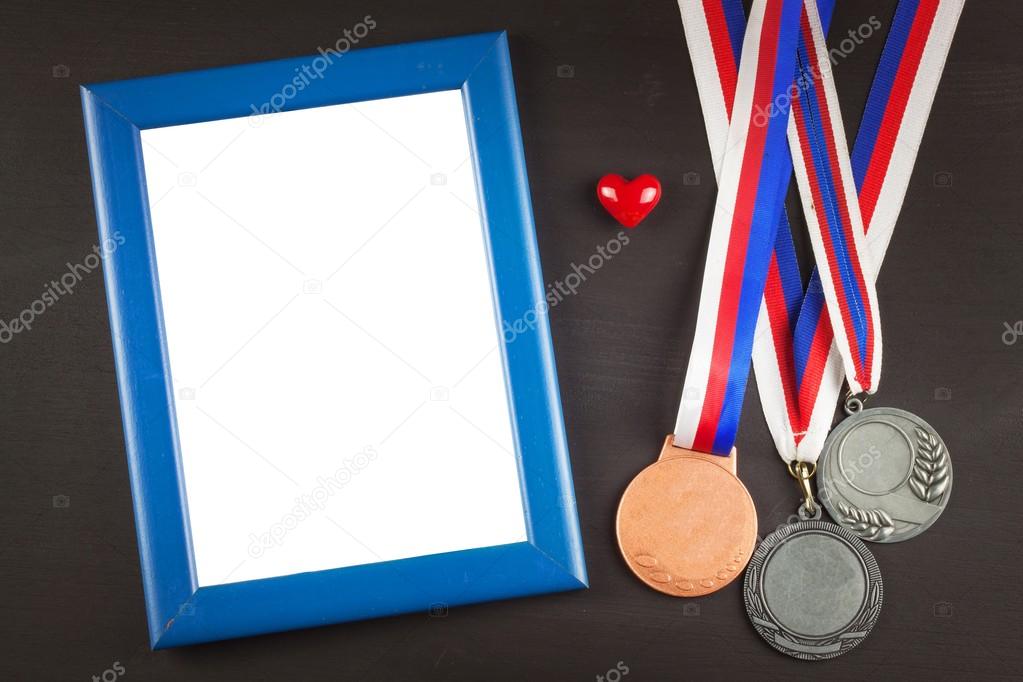 Sports medals on a wooden background. Collection of medals for the