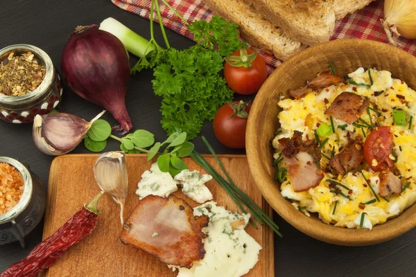 A breakfast full of protein. Scrambled eggs and bacon. A hearty meal for athletes. Homemade recipe for eggs.
