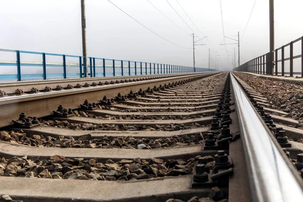 Railway tracks. Rail transport. Train transport. Autumn foggy morning. Rural landscape with railway tracks in the Czech Republic.