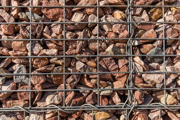 Retaining wall gabion baskets, Gabion wall caged stones textured background. Gabion wall caged stones.