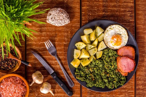 Traditional Czech Easter food. Spinach with potatoes and fried egg. Pork and spinach. Spring food. Spinach porridge.