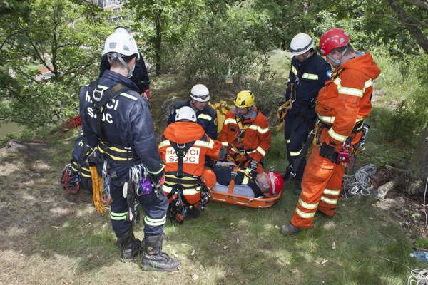 Kadan, Czech Republic, June 6, 2012: Exercise rescue units. Training rescue people in inaccessible terrain at the dam Kadan. Recovery using rope techniques