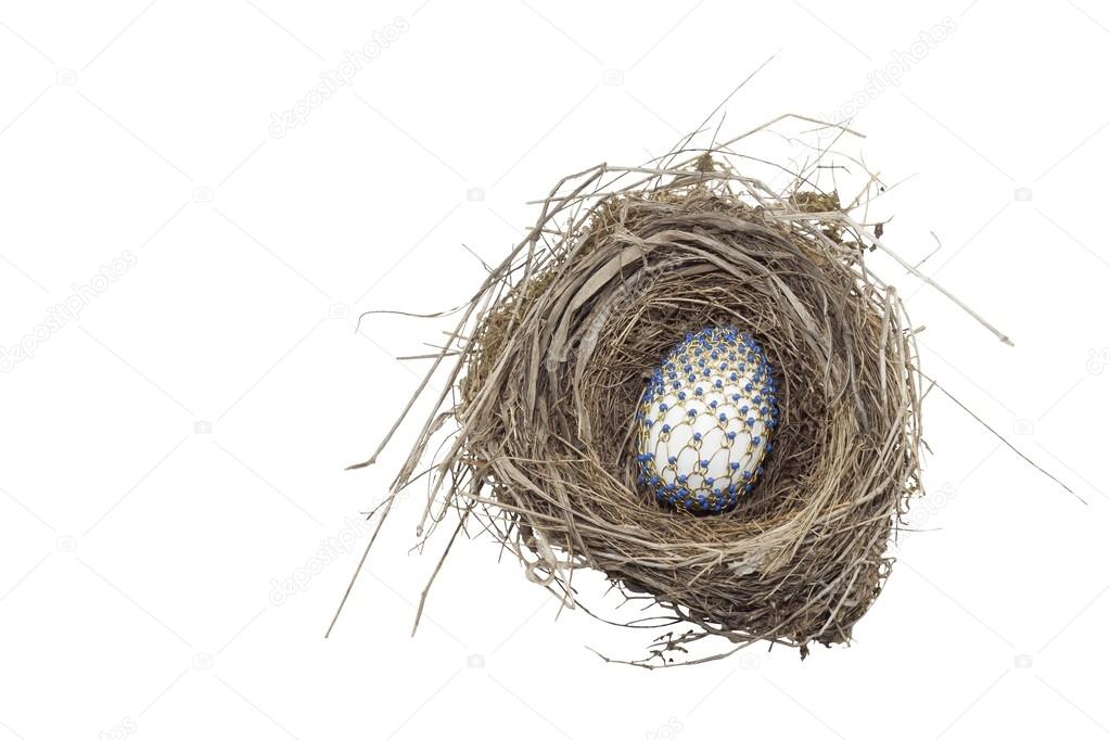 Decorated easter egg in the nest, braided of wire and beads