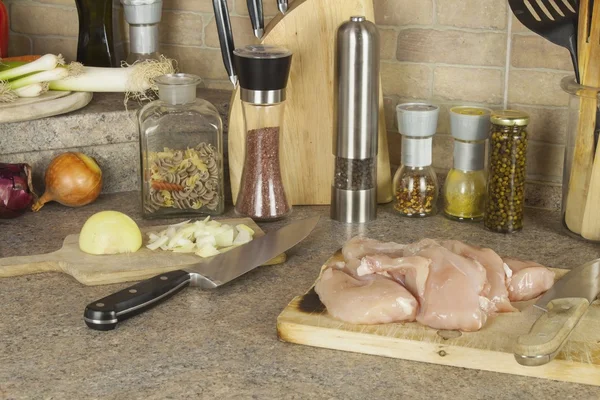 Homework chicken meat, slicing chicken breast fillet, kitchen table with ingredients for cooking — Stock Photo, Image