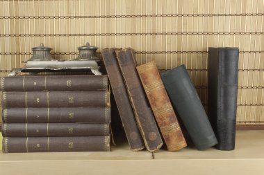 Front view of old books stacked on a shelf. Books without title and author. clipart