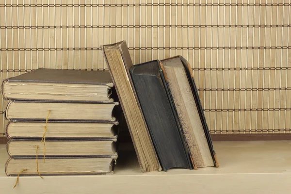 Front view of old books stacked on a shelf. Books without title and author. — Stock Photo, Image