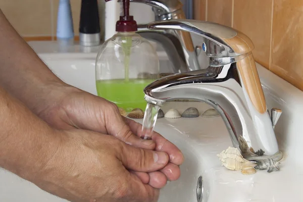 Чоловік миє руки в раковині. Гігієна в домашній ванній . — стокове фото