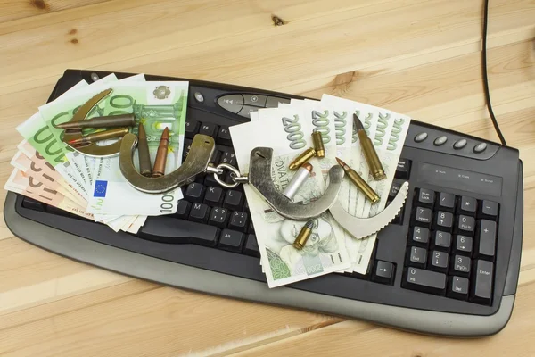 Internet illegal arms trade. Merchant arrest illegal ammunition. Internet crime. Current euro banknotes and Czech koruna. — Stockfoto