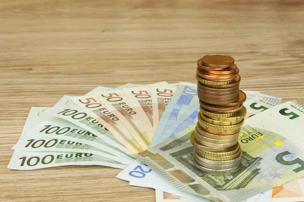 Euro coins and banknotes on the table. Detailed view of the legal tender of the European Union, EU. The uncertain future of the euro. — Stock Photo, Image