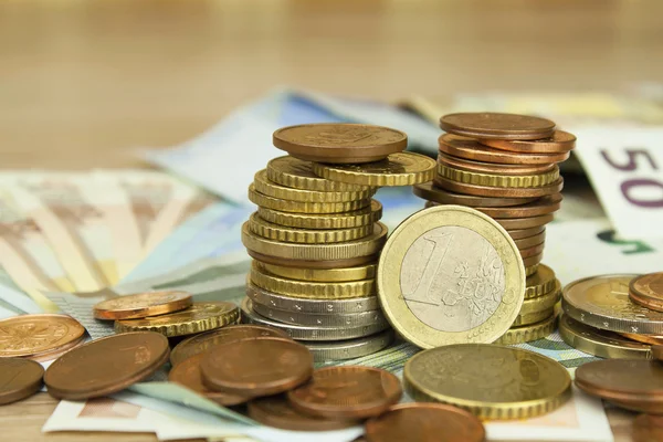 Euro coins and banknotes on the table. Detailed view of the legal tender of the European Union, EU. The uncertain future of the euro. — Stock Photo, Image