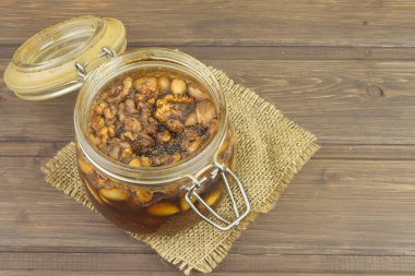 Jar of honey and nuts. Sweet treat for snacking. Pickled walnuts in honey. The ingredients for the sweet taste of dessert.