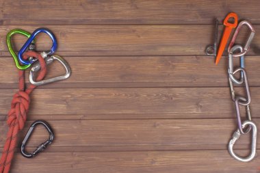 Used climbing gear on wooden background. Advertising boards of trade. The concept of extreme sports. Decoration of older equipment climbers.