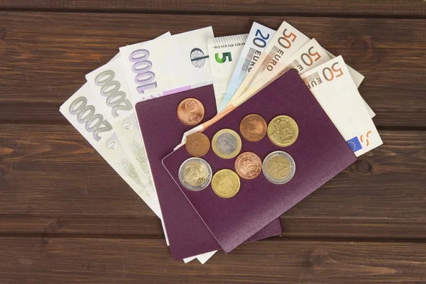 Passport and money on wooden table. Valid EURO banknotes, coins and banknotes Czech. Illegal migration for money. Paying smugglers for crossing the border. — Stock Photo, Image