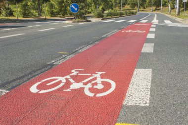 Bicycle path drawn on the asphalt road. Lanes for cyclists. Traffic signs and road safety. Cycleway in Brno, Czech Republic