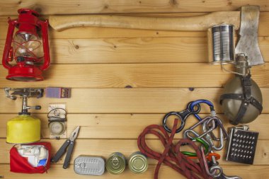 Preparing for summer camping. Things needed for an epic adventure. Sales of camping equipment. Packaging equipment for camping. Camping equipment on a wooden board.