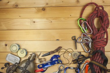Used climbing gear on wooden background. Advertising boards of trade. The concept of extreme sports. Decoration of older equipment climbers