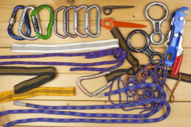 Used climbing gear on wooden background. Advertising boards of trade. The concept of extreme sports. Decoration of older equipment climbers