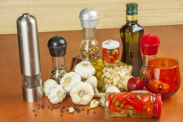 Spices and ingredients to prepare meat for grilling. Garlic, aromatic ingredients for flavoring food. Home remedy for colds and flu. Garlic marinated in olive oil. Seasoning food. — Stock Photo, Image