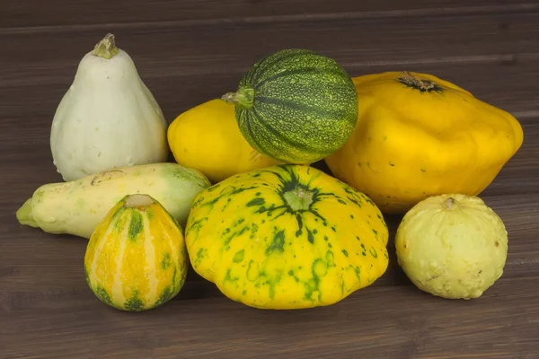 Höstens skörd av pumpor. Förbereda för Halloween. Odla grönsaker i en hem trädgård. Plats för din text. Hösten pumpor med blad på träskiva — Stockfoto