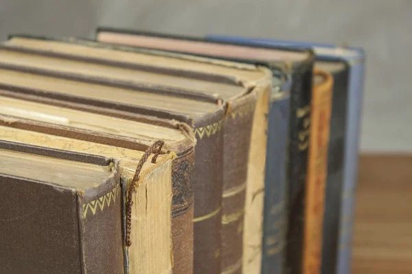 Front view of old books stacked on a shelf. Books without title and author. — Stock Photo, Image