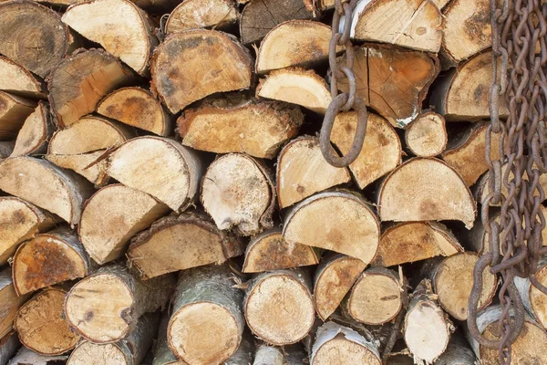 Background of stacked wood. Various kinds of wooden logs stacked on top of each other. Stack of wood, firewood, background. Dry chopped firewood logs ready for winter. — Stock Photo, Image