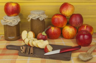 Domestic production of apple marmalade and cinnamon. Apple jam on the kitchen table. Processing autumn harvest of apples